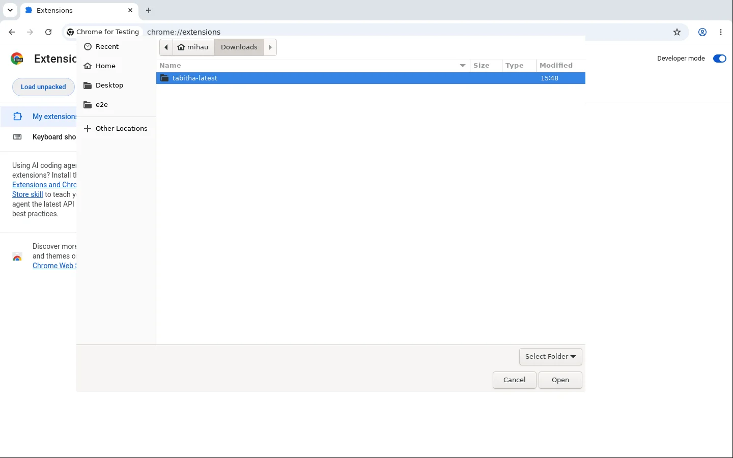 The folder picker open over the extensions page, showing the downloads folder with the unpacked tabitha-latest folder selected and the Open button ready.